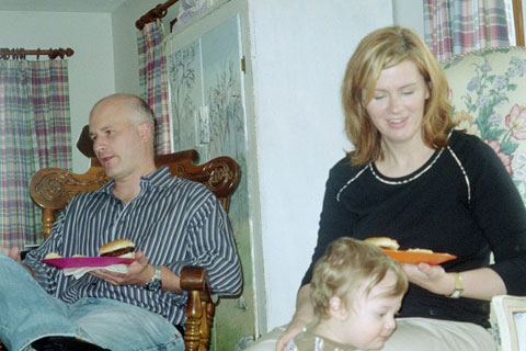 Man and Woman Enjoying Food with Child